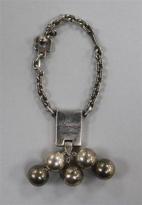 A white metal key ring fob, inscribed S.J. Dupont, Paris, 1789-1989.